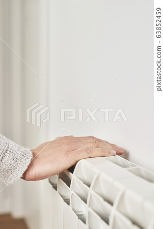 man touching a radiator man touching a radiator 63852459