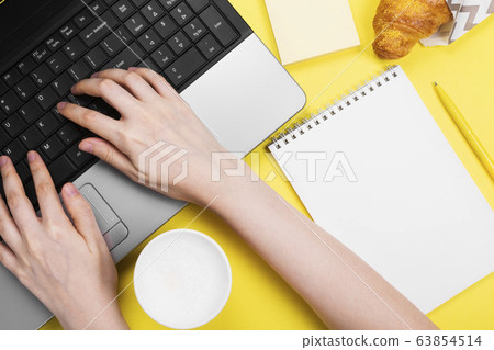 Working morning. Girl works for laptop. Breakfast 63854514