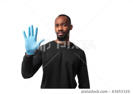 How coronavirus changed our lives. Young man holding thermometer, taking temperature on white background 63855320