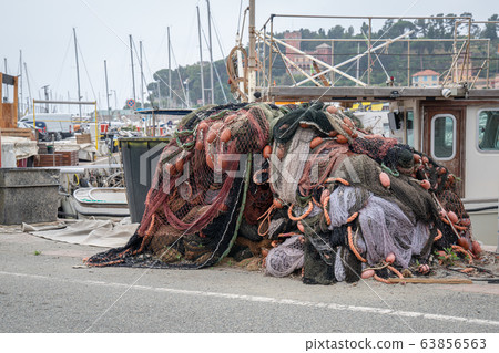 Fishing nets stacked on the waterfront 63856563