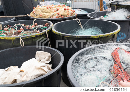 Fishing nets inside huge plastic bins Fishing nets inside huge plastic bins 63856564