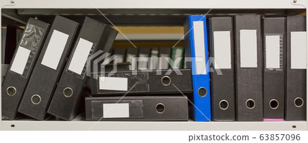 A few of archive folders in the office shelf. 63857096