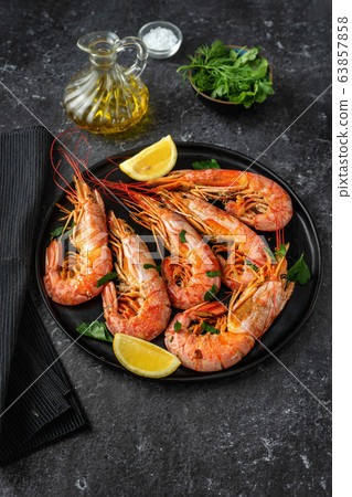 Vertical shot of a plate with red big prawns Vertical shot of a plate with red big prawns 63857858