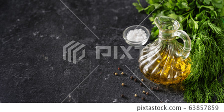 Herbs, olive oil and salt on black background Herbs, olive oil and salt on black background 63857859