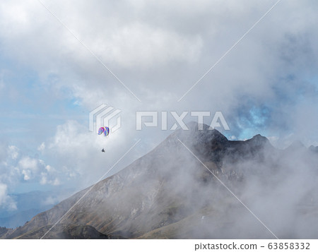 A man flies through a cloudy haze above the 63858332