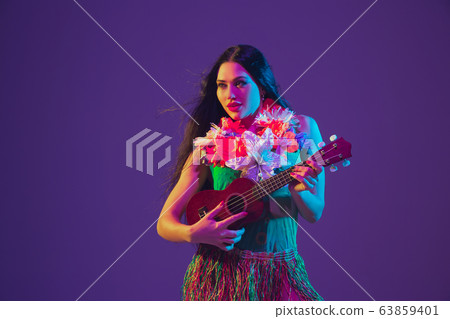 Fabulous Cinco de Mayo female dancer on purple studio background in neon light Fabulous Cinco de Mayo female dancer on purple studio background in neon light 63859401