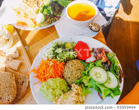 Vegan brunch in cafe, salad, soup and bread as healthy meal 63859494