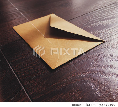 Golden vintage envelope on wooden background, newsletter and message Golden vintage envelope on wooden background, newsletter and message 63859499