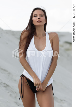 Pretty female in beachwear on nature background 63860775