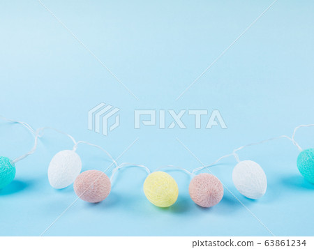 Easter egg shaped holiday lights string on blue Easter egg shaped holiday lights string on blue 63861234