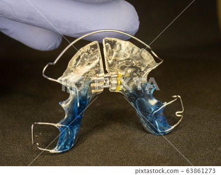 Dentist show dental retainer orthodontic appliance 63861273