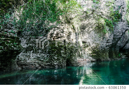 mountain river of high stone cliffs with green plants in the Martvili Canyon in Georgia mountain river of high stone cliffs with green plants in the Martvili Canyon in Georgia 63861350