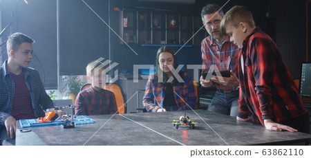 Students watching flying drone in class 63862110