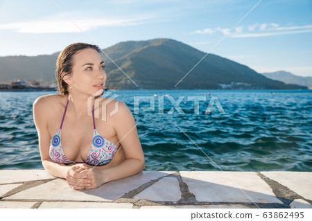 Nice lady posing in the water 63862495