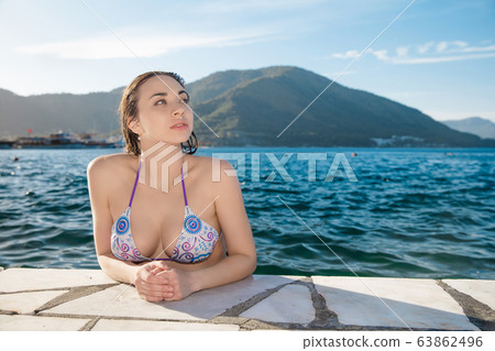 Lovely lady posing in the water 63862496