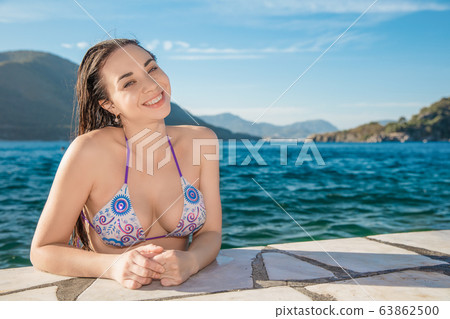 Adorable brunette posing in the water 63862500