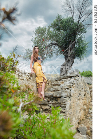 Cute lady posing among antique ruins 63862839