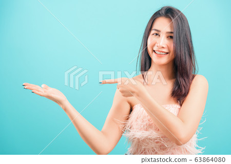 Smiling face Asian beautiful woman her point Smiling face Asian beautiful woman her point 63864080