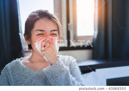 Sick asian woman have hight fever flu and sneezing Sick asian woman have hight fever flu and sneezing 63868503