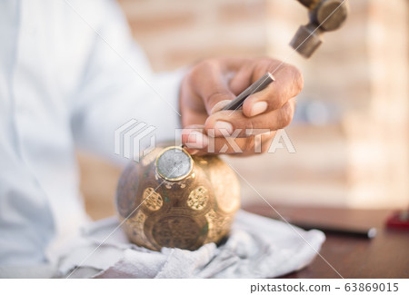 chaser of copper at work 63869015