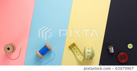 sewing tools and accessories at paper background 63879907