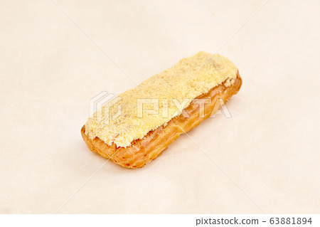 Eclair cake, delicious pastries closeup on a light Eclair cake, delicious pastries closeup on a light 63881894