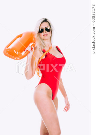 Lifeguard in red sexy swimsuit with lifeguard rescue can floating buoy Lifeguard in red sexy swimsuit with lifeguard rescue can floating buoy 63882178