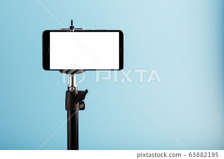 Mobile phone on a tripod with a clear white 63882195