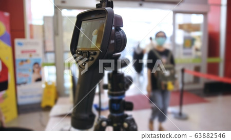 Temperature check at a supermarket, grocery store with a thermal imaging camera installed. Coronavirus pandemic outbreak. 63882546