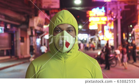 Man close up look caucasian at Pattaya Walking Street with wearing protective medical mask. Lockdown quarantine isolation. Coronavirus covid-19. 63882555