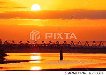 Keio Line passing the morning glow and Tamagawa Bridge 63884371