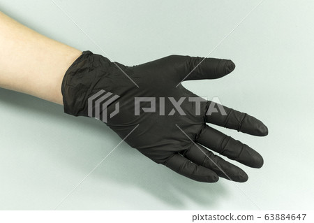 Hand gestures on a gray background in a sterile rubber glove shot with a large lan. 63884647
