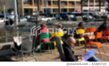 Unidentified tourists and locals rest around artificial pond on Rabin Square in Tel Aviv. Ibn Gvirol Street. Blurred view Unidentified tourists and locals rest around artificial pond on Rabin Square in Tel Aviv. Ibn Gvirol Street. Blurred view 63885720
