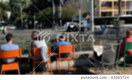 Unidentified tourists and locals rest around artificial pond on Rabin Square in Tel Aviv. Ibn Gvirol Street. Blurred view Unidentified tourists and locals rest around artificial pond on Rabin Square in Tel Aviv. Ibn Gvirol Street. Blurred view 63885724