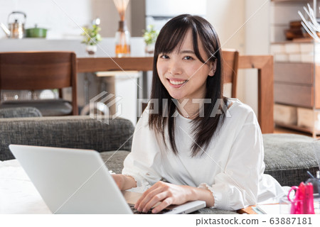 Young woman playing computer at home Young woman playing computer at home 63887181