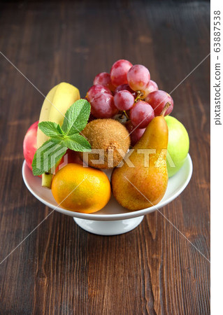 Whole fruits on a white plate. Restaurant menu Whole fruits on a white plate. Restaurant menu 63887538