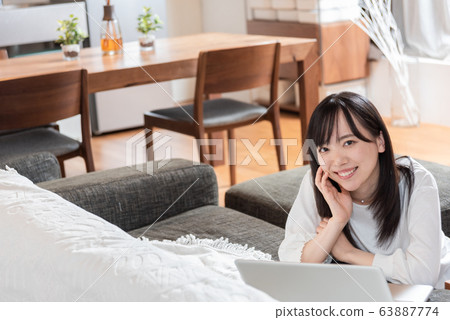 A young woman relaxing at home A young woman relaxing at home 63887774