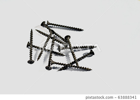 Long dark metal screws for mounting on a wooden surface .. Long dark metal screws for mounting on a wooden surface .. 63888341