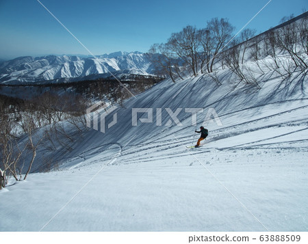 Mountain skier gliding to Snow Tsugaike Nature Park Mountain skier gliding to Snow Tsugaike Nature Park 63888509