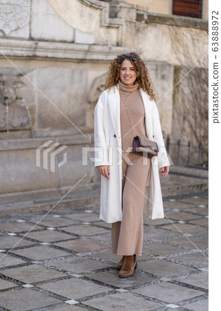 Pretty woman with fashionable clothes. Tourism in the city 63888972