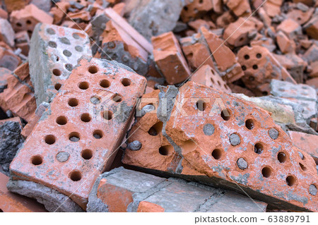 Old and broken bricks dumped in a pile after the demolition of a building Old and broken bricks dumped in a pile after the demolition of a building 63889791
