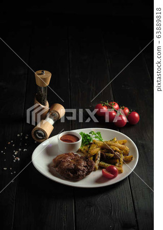 Meat medallion and french fries . catering menu 63889818