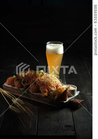 Glass of cold beer with appetizer. catering menu Glass of cold beer with appetizer. catering menu 63889886