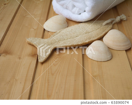 Towel,shells and luffa wisp on the wooden Towel,shells and luffa wisp on the wooden 63890074