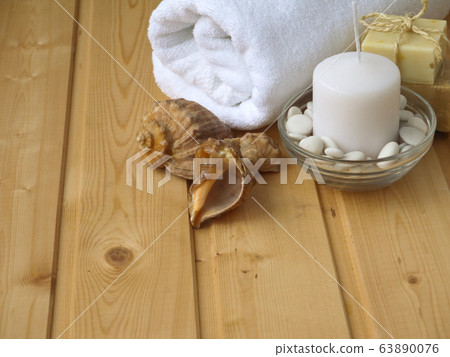 Towel,soap,candle and shells on the wooden 63890076