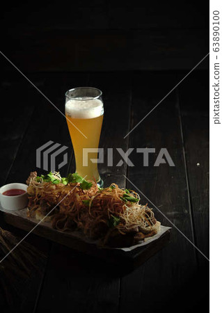 Glass of cold beer with appetizer. catering menu 63890100