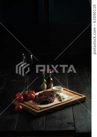 Meat steak on a wooden board. catering menu 63890116