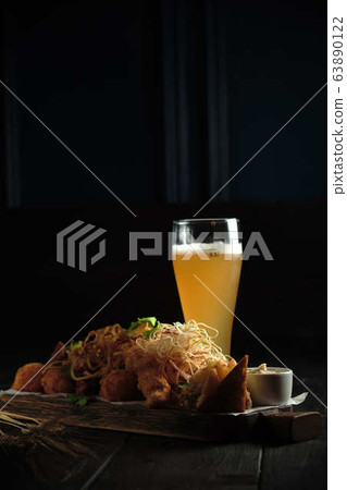 Glass of cold beer with appetizer. catering menu 63890122