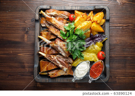 Barbecue on the bones with vegetables and potatoes . catering menu Barbecue on the bones with vegetables and potatoes . catering menu 63890124