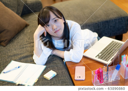 A young woman relaxing at home A young woman relaxing at home 63890860